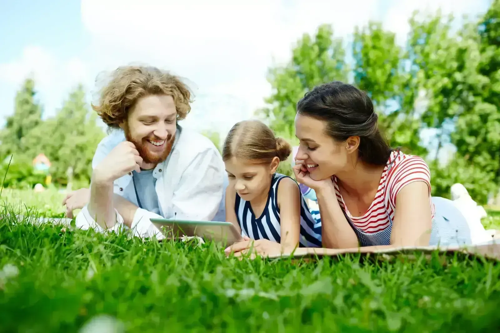 family-laying-in-grass